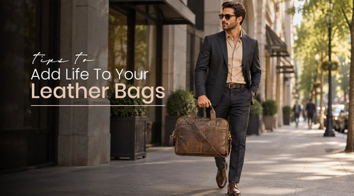 Stylish businessman carrying a brown leather laptop bag on a city street.