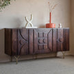 Alto Carved Three Door Sideboard in dark brown styled with vases