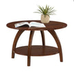 Arlo brown round coffee table styled with an open book and a potted plant