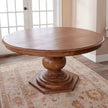Bastia Round Pedestal Solid Wood Dining Table on a patterned rug