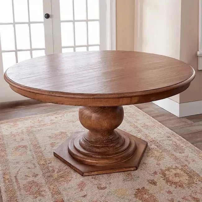 Bastia Round Pedestal Solid Wood Dining Table on a patterned rug