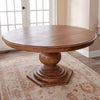 Bastia Round Pedestal Solid Wood Dining Table on a patterned rug