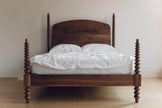 Bodhi Bobbin Four Poster Solid Wood Bed with arched headboard and white bedding