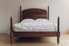 Bodhi Bobbin Four Poster Solid Wood Bed with arched headboard and white bedding