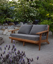 Breeze Teak Frame Sofa in a garden