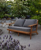 Breeze Teak Frame Sofa in a garden