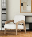Cirrus Boucle Curved Arm Lounge Chair in a room with shelves