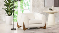 Cocoon Boucle Wooden Base Armchair in a living room with plants