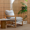 Cove Sling Back Wooden Armchair with a plant