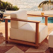 Cylinder Arm Solid Teak Lounge Chair in a warm setting