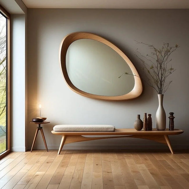Drift Asymmetrical Wooden Wall Mirror above a low bench in a sunlit room