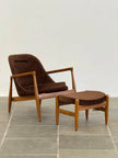Elsa Wooden Lounge Armchair with ottoman on a stone floor