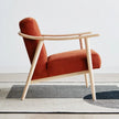 Fjord Upholstered Wooden Lounge Armchair in rust fabric