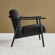 Fjord Upholstered Wooden Lounge Armchair charcoal in a room