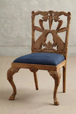 Hare Hand Carved Wooden Dining Chair with a blue upholstered seat