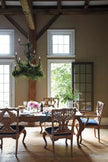 Hare Hand Carved Wooden Dining Chair around a dining table