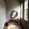 Mira Asymmetrical Wooden Wall Mirror in a bright hallway beside tall windows