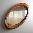 Oriel Oval Wooden Frame Wall Mirror seen at an angle against a white wall