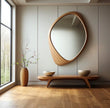 Pebble Irregular Wooden Frame Wall Mirror over a low wooden bench