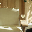 Pelago Teak Wood Lounge Chair against a wood wall