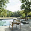 Pelago Teak Wood Lounge Chair beside a pool