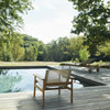 Pelago Teak Wood Lounge Chair beside a pool