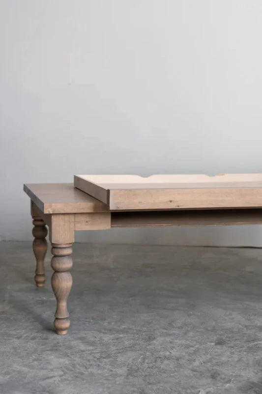 Rhea coffee table in natural wood finish with the hidden drawer partly open