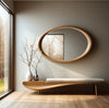 Selene Oval Solid Wood Wall Mirror above a low wooden bench with branches