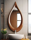 Teardrop Solid Wood Wall Mirror above a white bathroom basin