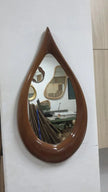 Teardrop Solid Wood Wall Mirror reflecting a living room