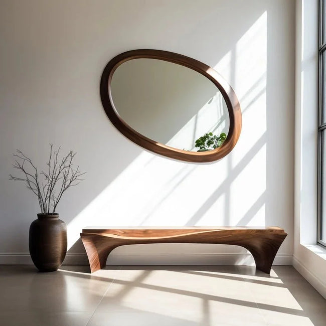 Wave Oval Walnut Wood Wall Mirror above a wooden bench with a vase